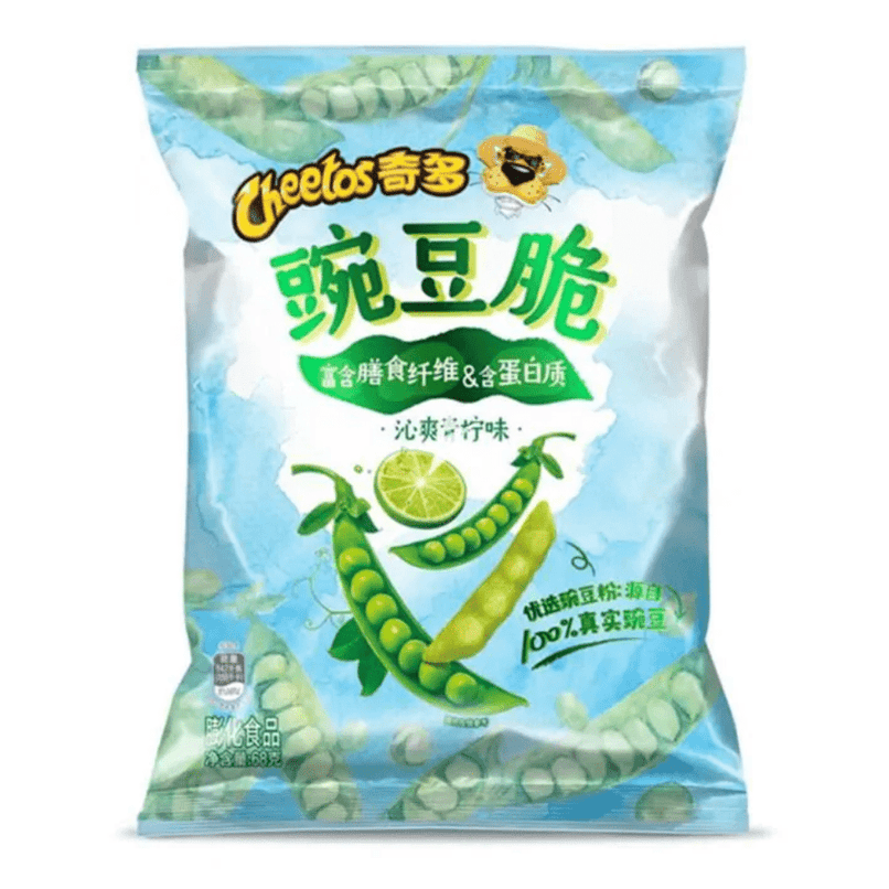 Un paquet bleu sur fond blanc avec des petits pois verts et une tranche de citron vert